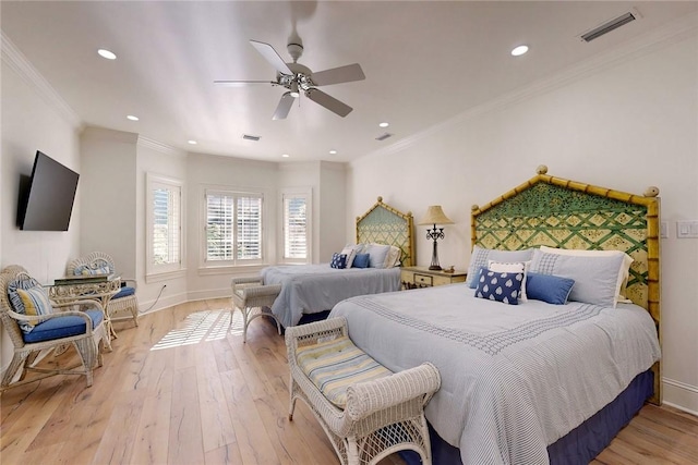 bedroom with ceiling fan, ornamental molding, and light wood-type flooring