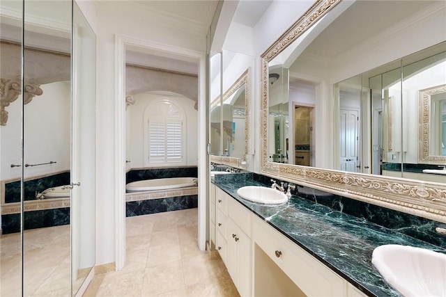 bathroom with ornamental molding, vanity, tiled bath, and tile patterned flooring