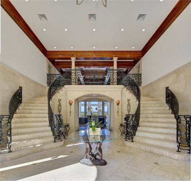 entryway with a high ceiling and ornamental molding