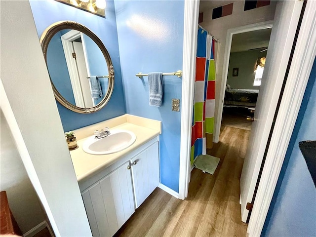622 Brockinton Pt, Saint Simons Island, GA 31522 - bathroom featuring wood finished floors, vanity, baseboards, and curtained shower