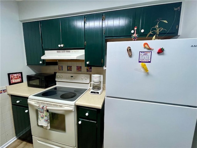 622 Brockinton Pt, Saint Simons Island, GA 31522 - kitchen with white appliances, under cabinet range hood, light countertops, and green cabinets