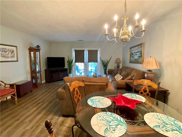 622 Brockinton Pt, Saint Simons Island, GA 31522 - dining room with a chandelier, french doors, a textured ceiling, and wood finished floors