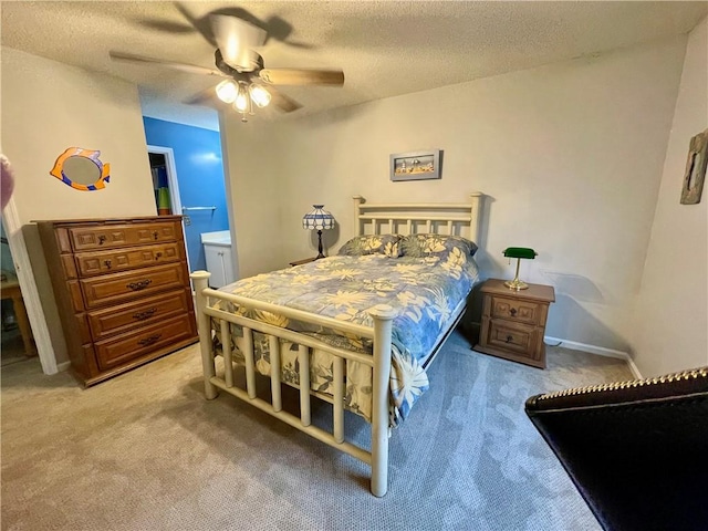 622 Brockinton Pt, Saint Simons Island, GA 31522 - bedroom with light carpet, a textured ceiling, a ceiling fan, and ensuite bath