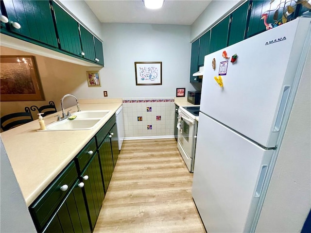 622 Brockinton Pt, Saint Simons Island, GA 31522 - kitchen featuring white appliances, green cabinets, a sink, light wood-style floors, and tile walls