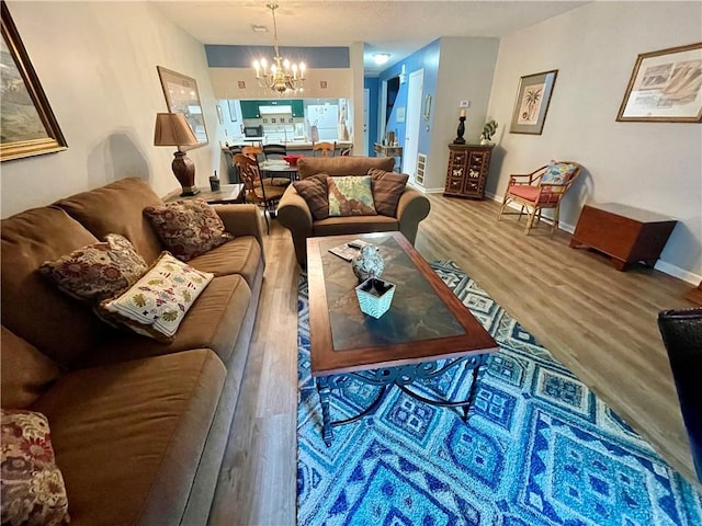 622 Brockinton Pt, Saint Simons Island, GA 31522 - living area with a chandelier, wood finished floors, and baseboards