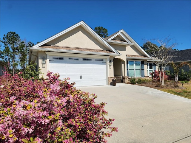 single story home featuring brick siding, stucco siding, a standing seam roof, metal roof, and a garage