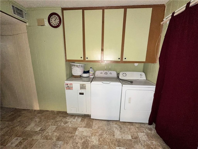 laundry area with cabinets and washing machine and clothes dryer