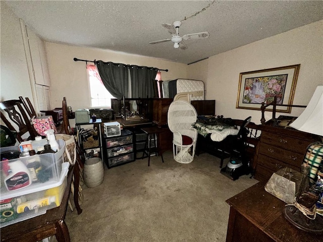 office space featuring ceiling fan, carpet floors, and a textured ceiling