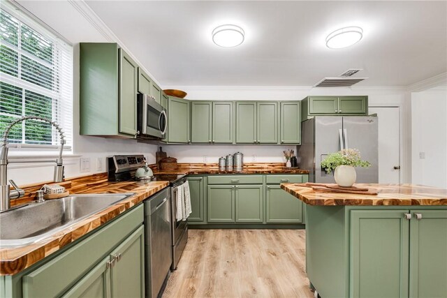 416 S Deals Cir, Woodbine, GA 31569 - kitchen with green cabinets, butcher block countertops, stainless steel appliances, and ornamental molding