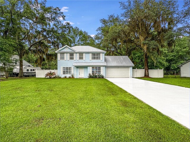 416 S Deals Cir, Woodbine, GA 31569 - view of front of house with driveway, a garage, and metal roof