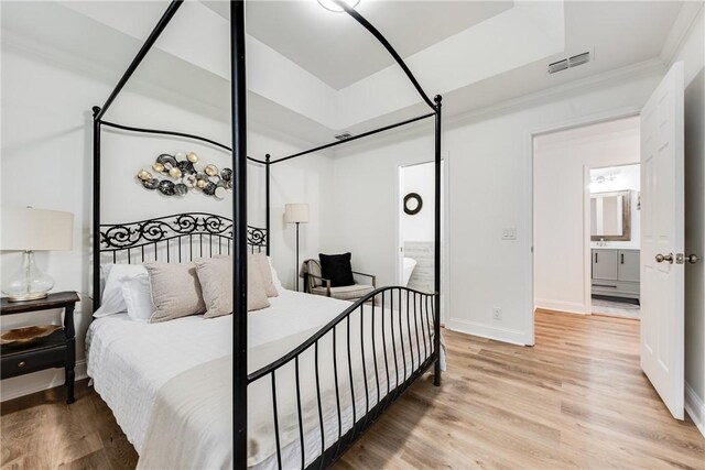 416 S Deals Cir, Woodbine, GA 31569 - bedroom with light wood-style floors, ensuite bath, ornamental molding, and baseboards