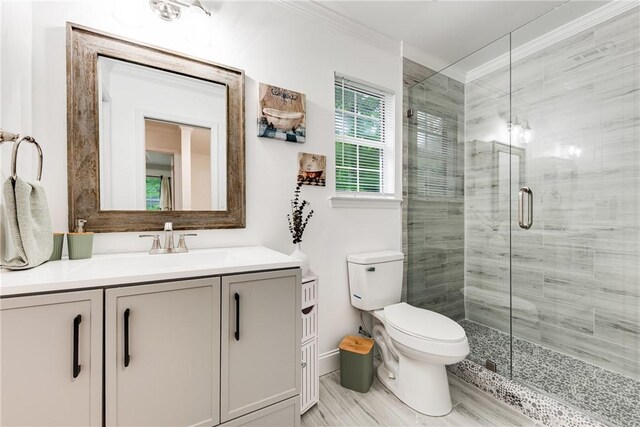 416 S Deals Cir, Woodbine, GA 31569 - bathroom featuring a shower stall, crown molding, vanity, toilet, and baseboards