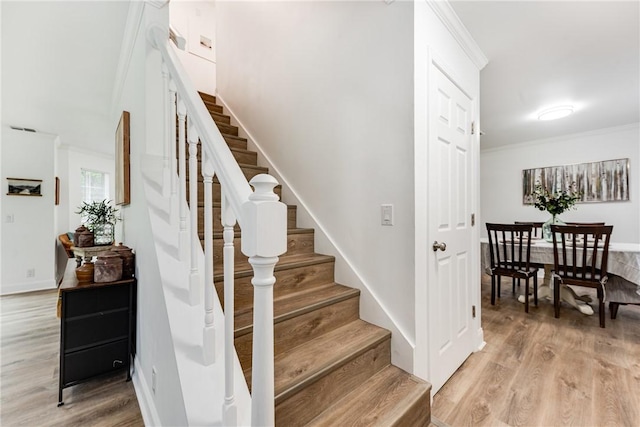 416 S Deals Cir, Woodbine, GA 31569 - stairs featuring wood finished floors, crown molding, and baseboards