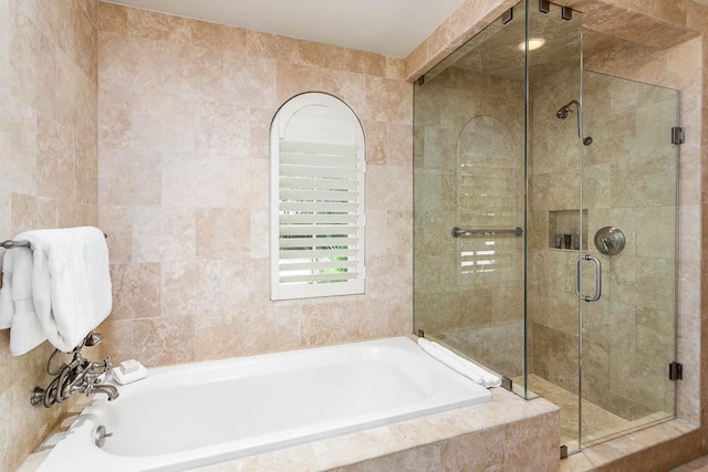 bathroom with plus walk in shower and tile walls