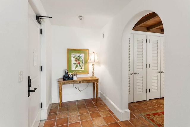 hallway with tile patterned flooring