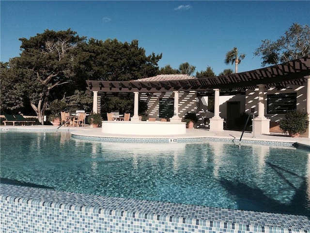 view of swimming pool featuring a pergola and a patio area