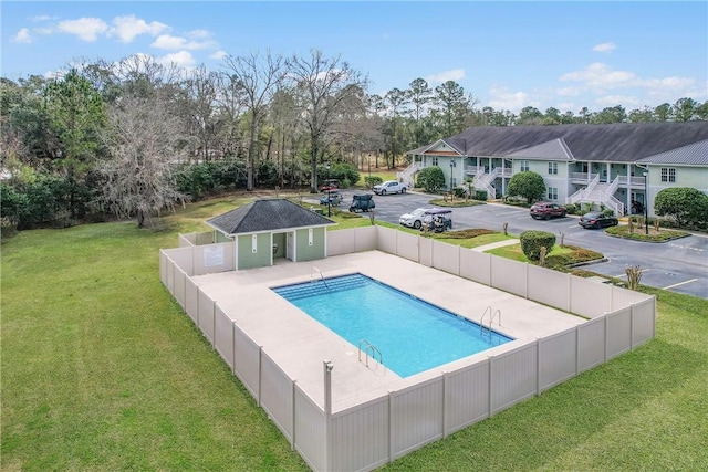 view of swimming pool with a fenced in pool, a patio, fence, and a lawn