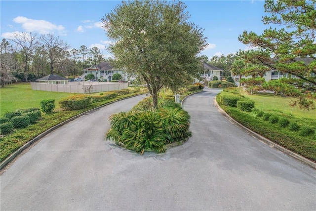 view of road featuring a residential view and curbs