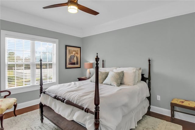 bedroom featuring a ceiling fan, baseboards, and wood finished floors