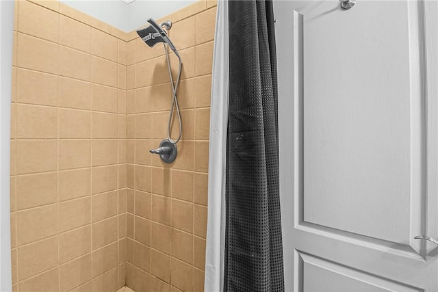 full bath with a tile shower