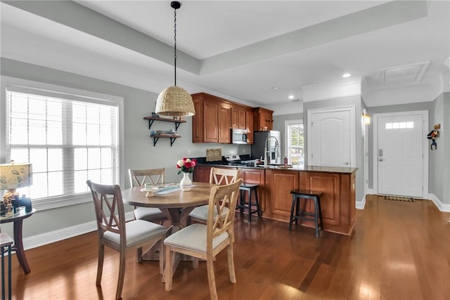 dining space with recessed lighting, dark wood-style flooring, a raised ceiling, and baseboards