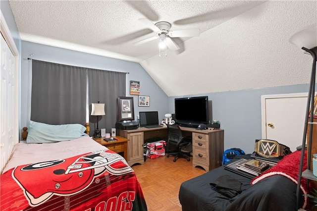 bedroom featuring ceiling fan, parquet flooring, a textured ceiling, and lofted ceiling