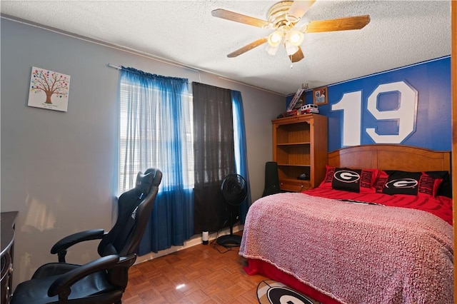 bedroom featuring parquet flooring, a textured ceiling, and ceiling fan