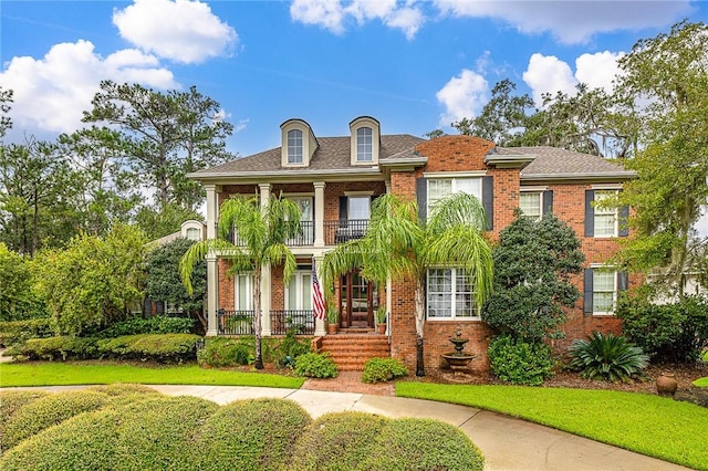 view of front of property featuring a porch and a balcony