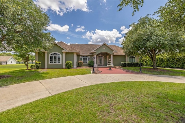 110 Rachel Way, Brunswick, GA 31523 - mediterranean / spanish house with stucco siding and a front lawn