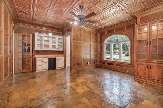 110 Rachel Way, Brunswick, GA 31523 - unfurnished office with ceiling fan, crown molding, wood walls, an ornate ceiling, and stone tile flooring