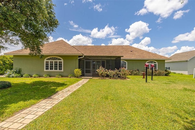 110 Rachel Way, Brunswick, GA 31523 - back of house featuring a sunroom, a yard, and stucco siding