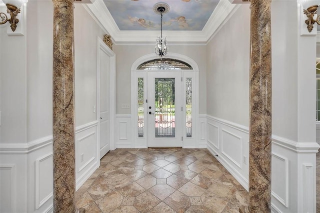 110 Rachel Way, Brunswick, GA 31523 - entryway with a decorative wall, a chandelier, stone tile floors, wainscoting, and decorative columns