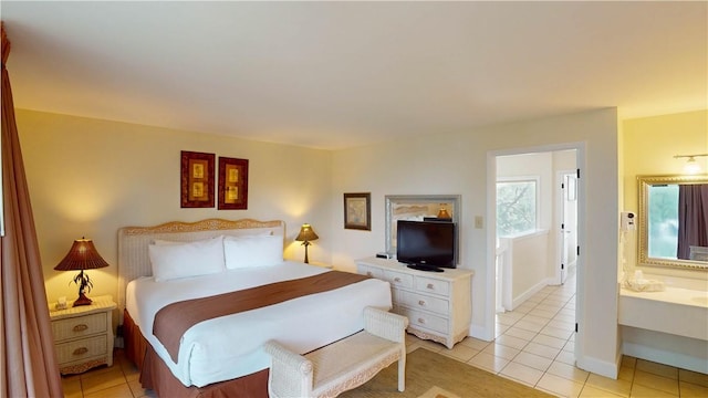 tiled bedroom featuring ensuite bath