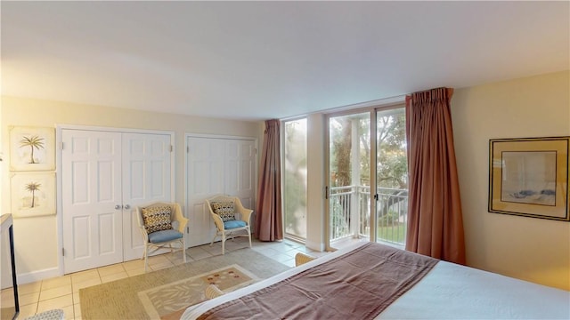 tiled bedroom with access to exterior and two closets