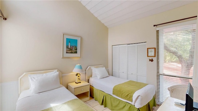 1175 N Beachview Dr Unit 427, Jekyll Island, GA 31527 - bedroom with vaulted ceiling, a closet, and wainscoting
