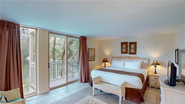 tiled bedroom featuring access to exterior and multiple windows