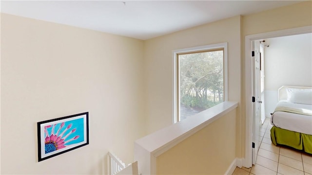 hall featuring light tile patterned floors