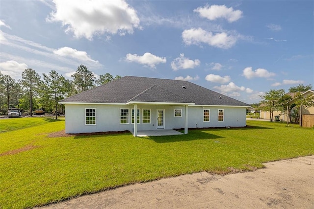 117 Rachel Way, Brunswick, GA 31523 - rear view of property with stucco siding, a yard, a patio area, and roof with shingles