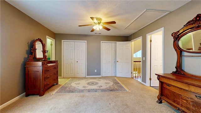 1457 N River Oaks Dr, Blackshear, GA 31516 - bedroom with light carpet, multiple closets, attic access, and a ceiling fan