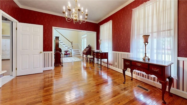 1457 N River Oaks Dr, Blackshear, GA 31516 - dining space featuring hardwood / wood-style flooring, stairway, a chandelier, a wainscoted wall, and crown molding