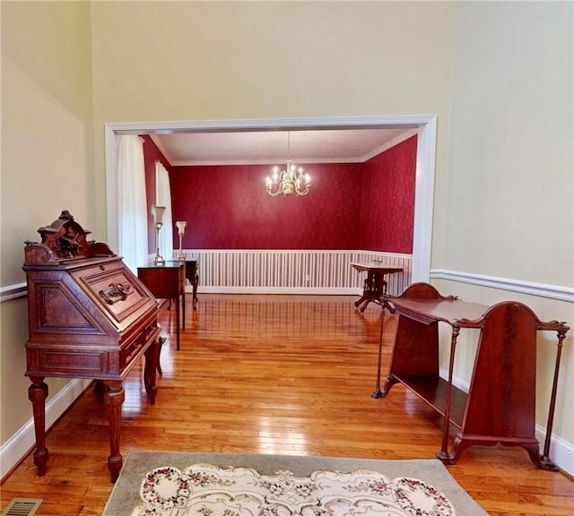1457 N River Oaks Dr, Blackshear, GA 31516 - hallway with wood-type flooring, ornamental molding, and a chandelier