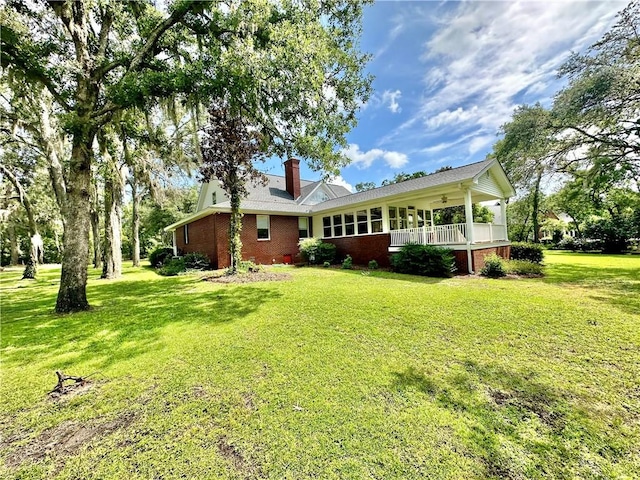 1457 N River Oaks Dr, Blackshear, GA 31516 - back of house featuring a lawn, a chimney, brick siding, and ceiling fan