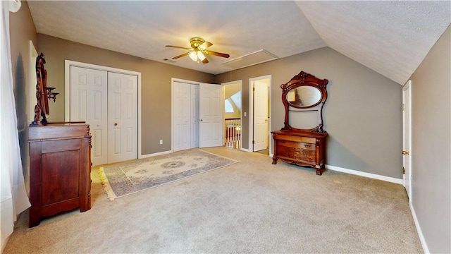 1457 N River Oaks Dr, Blackshear, GA 31516 - unfurnished bedroom featuring carpet flooring, two closets, a ceiling fan, and vaulted ceiling