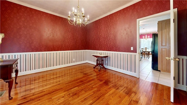 1457 N River Oaks Dr, Blackshear, GA 31516 - empty room with a chandelier, wood-type flooring, and crown molding