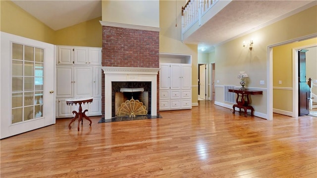 1457 N River Oaks Dr, Blackshear, GA 31516 - living area featuring light wood-type flooring, high vaulted ceiling, and a fireplace with flush hearth