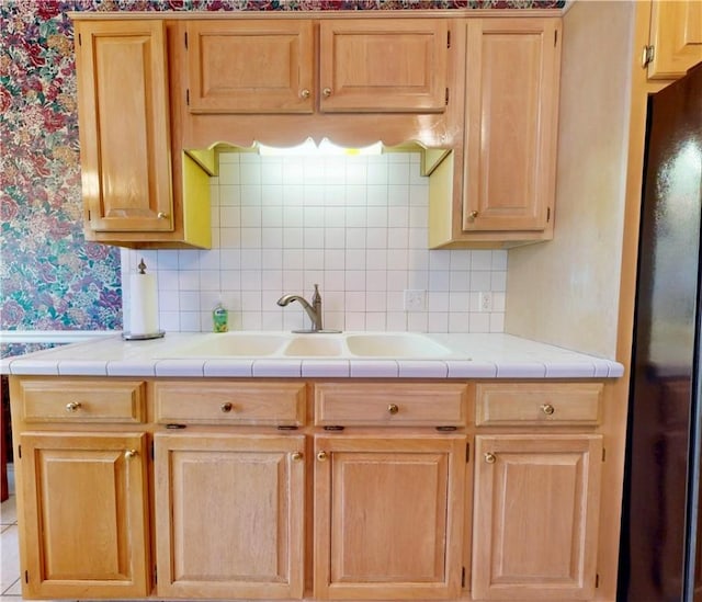 1457 N River Oaks Dr, Blackshear, GA 31516 - kitchen with freestanding refrigerator, backsplash, wallpapered walls, and light brown cabinets