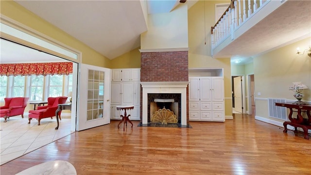 1457 N River Oaks Dr, Blackshear, GA 31516 - living area with light wood-style flooring, high vaulted ceiling, and a fireplace with flush hearth