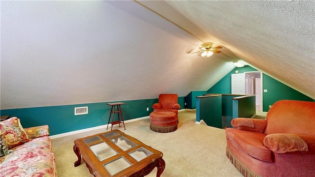 1457 N River Oaks Dr, Blackshear, GA 31516 - carpeted living room featuring vaulted ceiling, a textured ceiling, and a ceiling fan