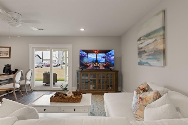 living room with ceiling fan and dark hardwood / wood-style flooring