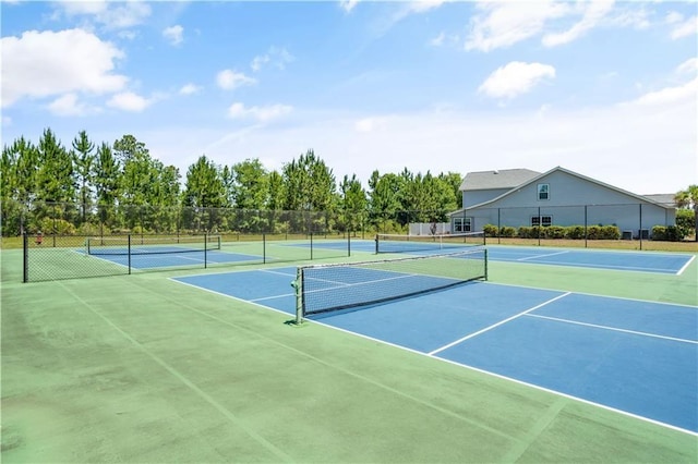 view of tennis court featuring basketball hoop